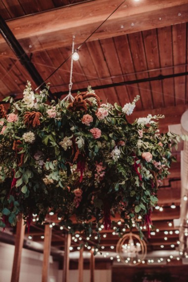 a hanging hoop of flowers and greenery.